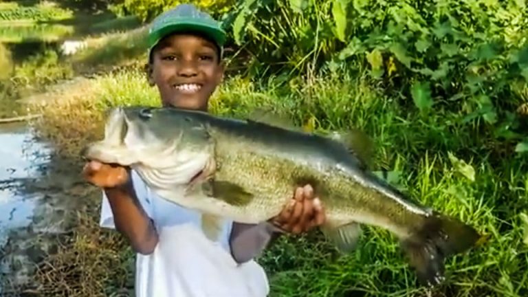 Young Man Catches, Releases Huge Bass from Bank