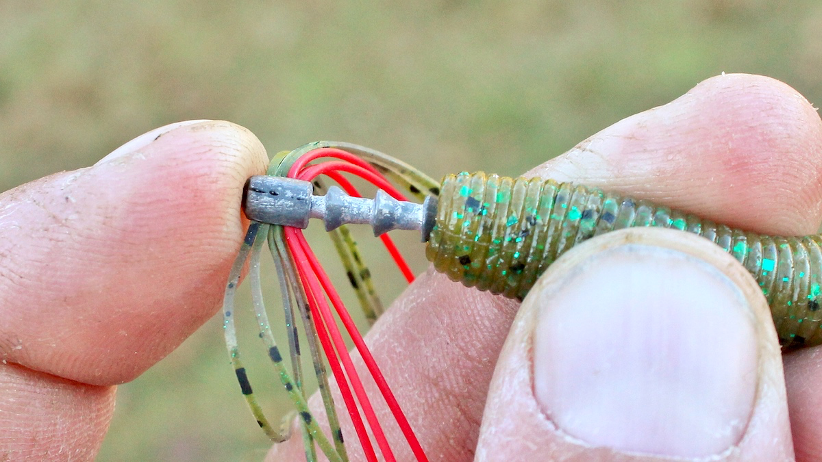 weight being inserted into neko rig for bass fishing
