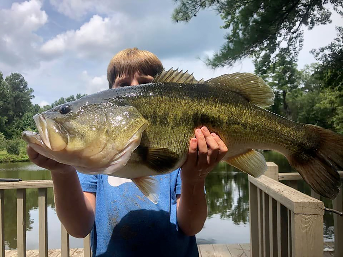 young angler holding big bass