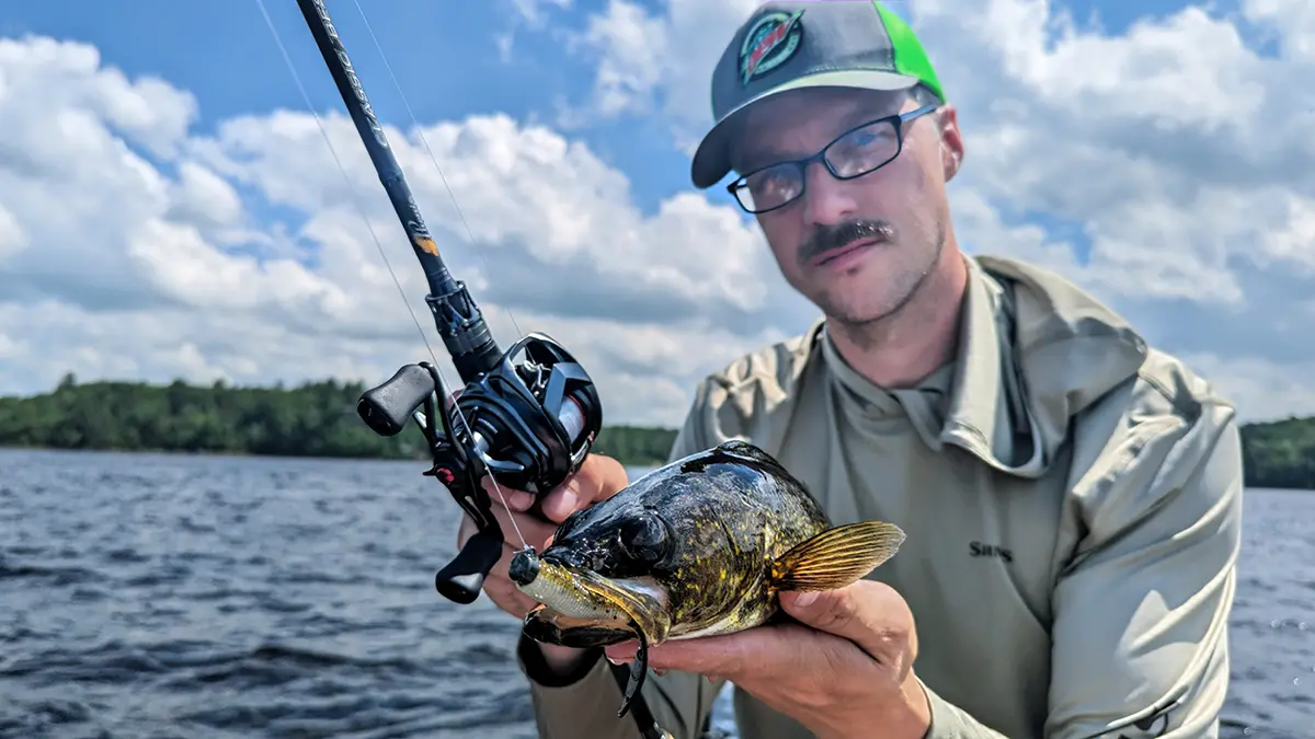 Hobie Wan Kenobi holding a walleye he caught using the Daiwa Tatula BF TW 70 reel