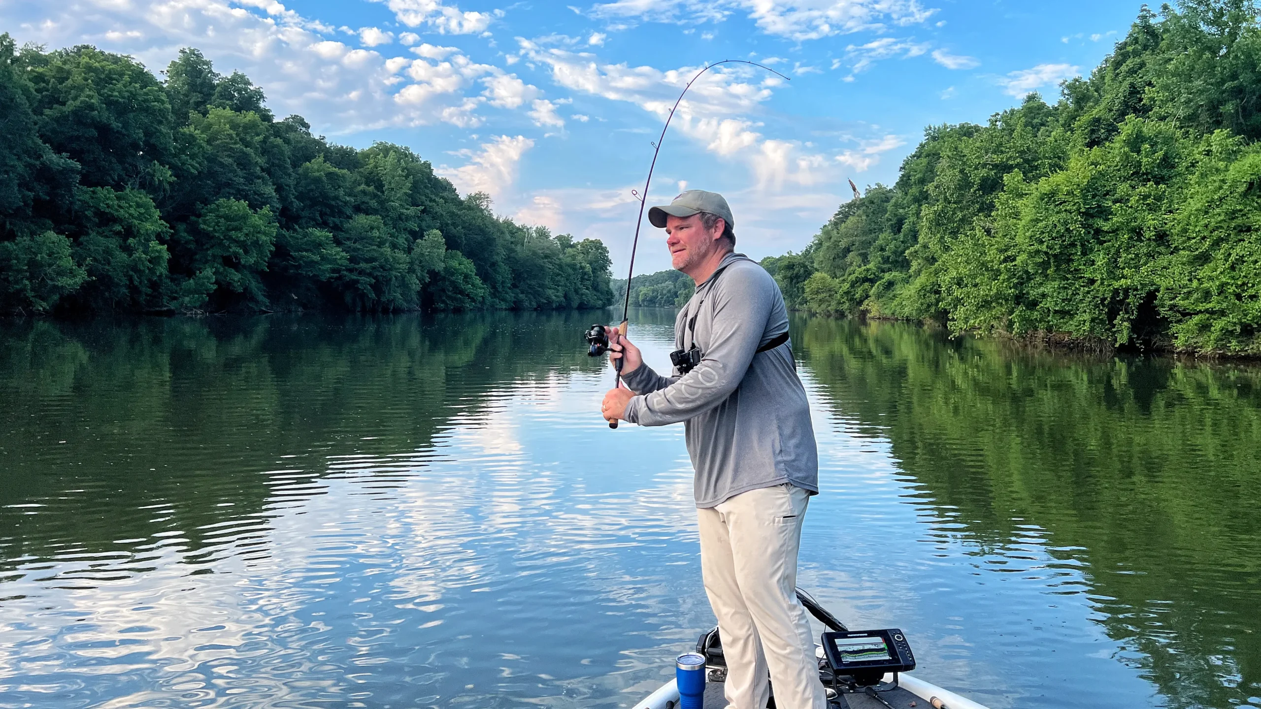 angler on a boat casting a spinning reel