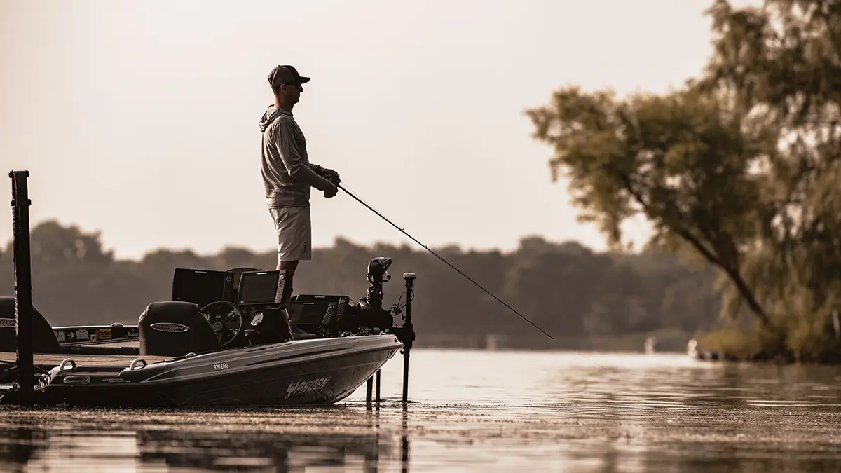 Angler standing on a boat reeling in line