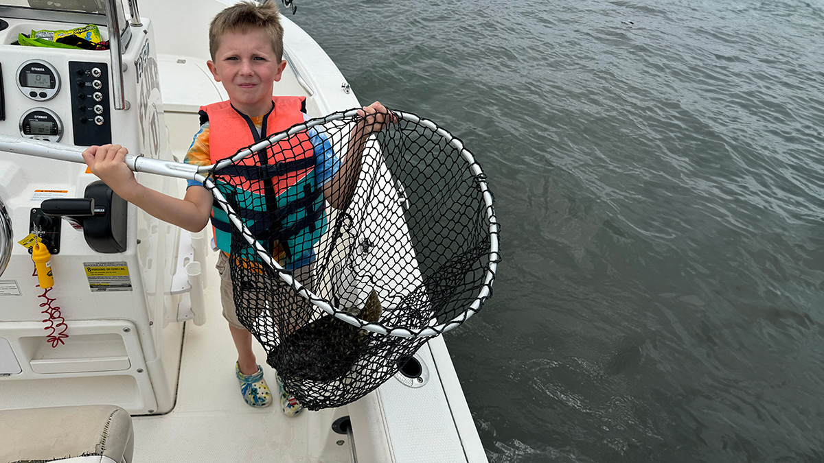 child with summer flounder