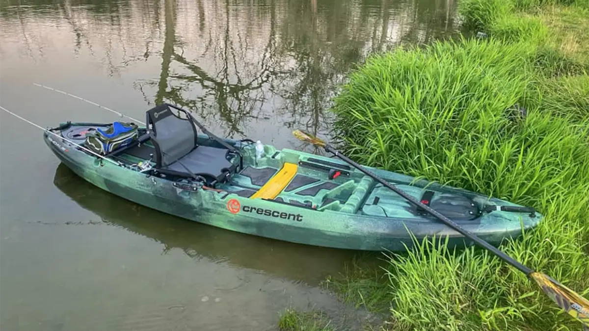  A kayak in the water with a leaderboard nestled into the kayak