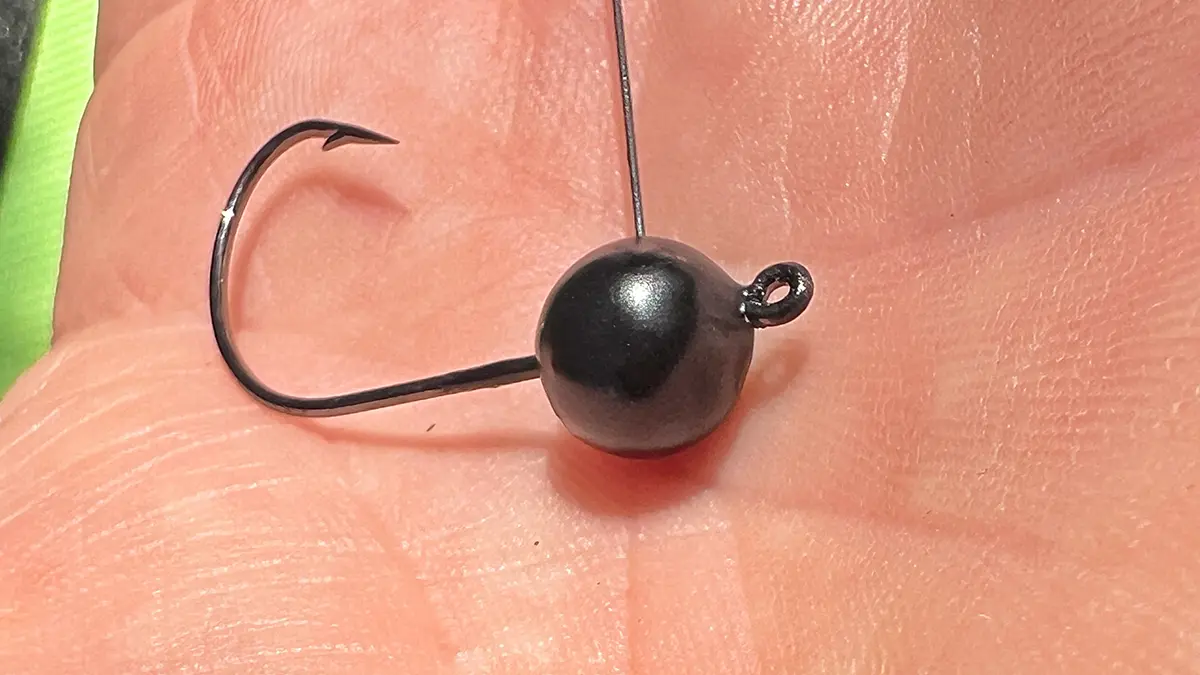 close up in palm of hand of the WOO Tungsten Wacky Jig Hook and Ball