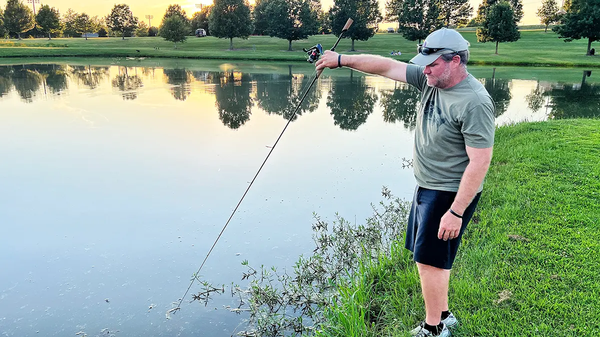 angler dropping a bait with a spinning reel