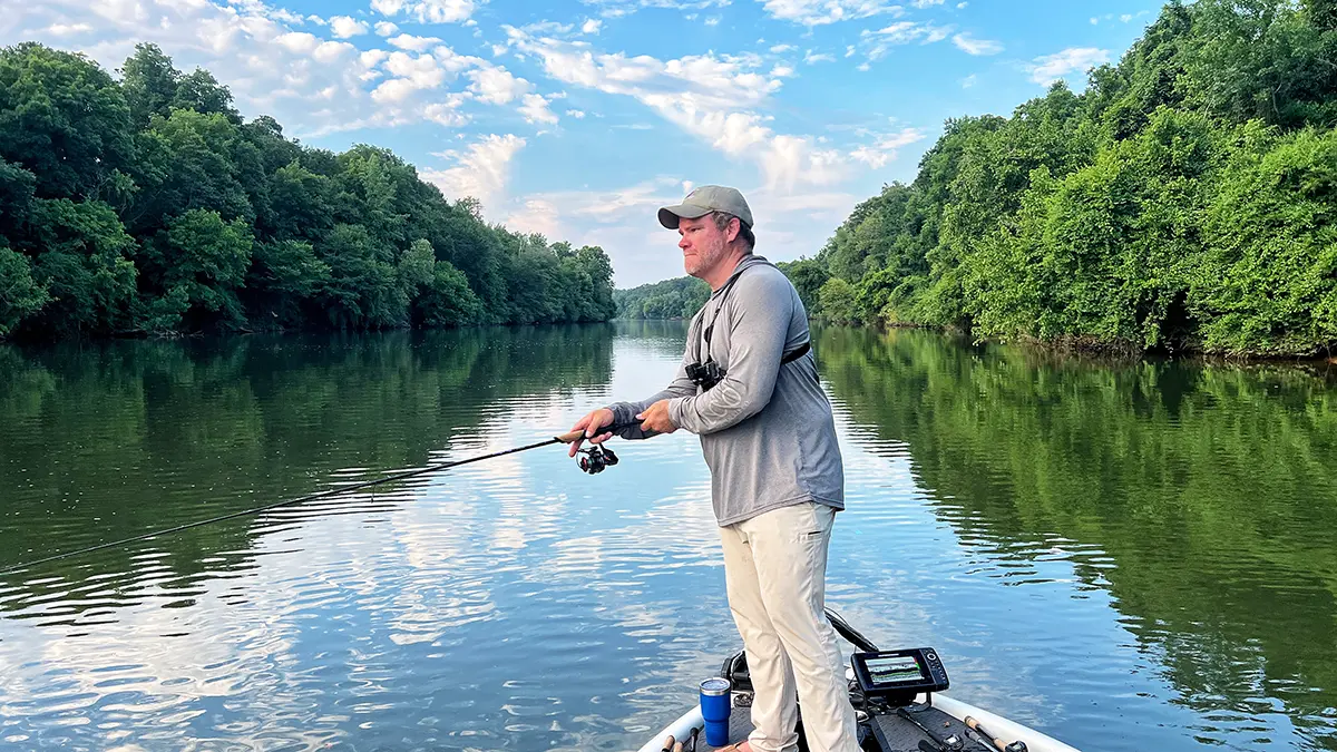 angler on a boat lowering his st. croix rod