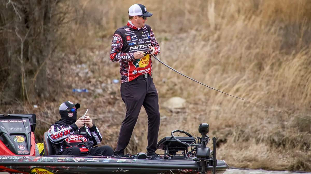 KVD standing on a boat reeling in