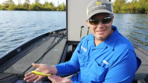 Keith Combs on a boat holding a Carolina rig