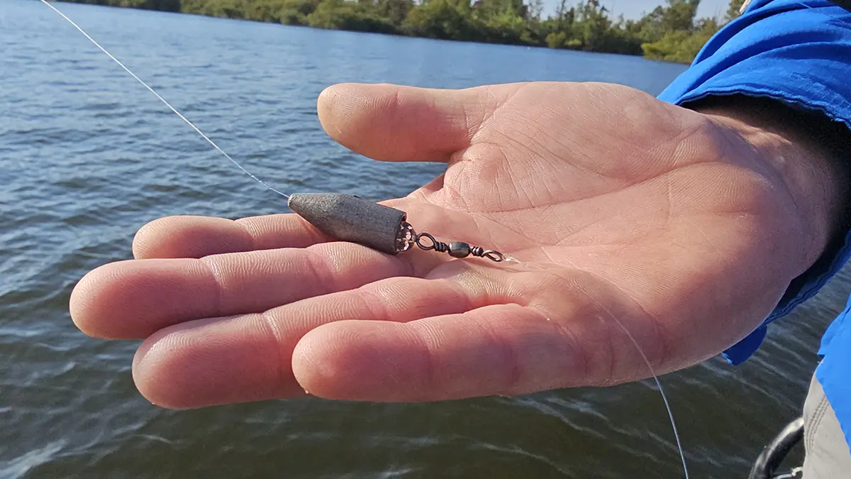 close up of Keith Combs holding a Carolina rig weight