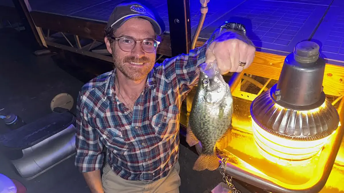 Kyle Stewart with crappie at night