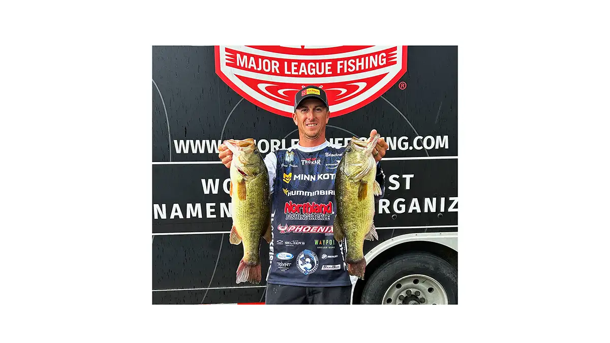 Tournament winner holding up two bass at MLF