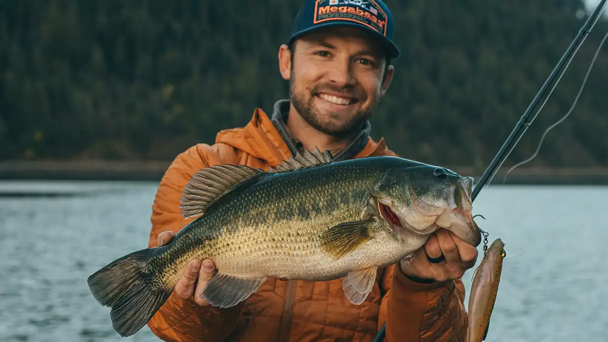 close up of man holding large bass