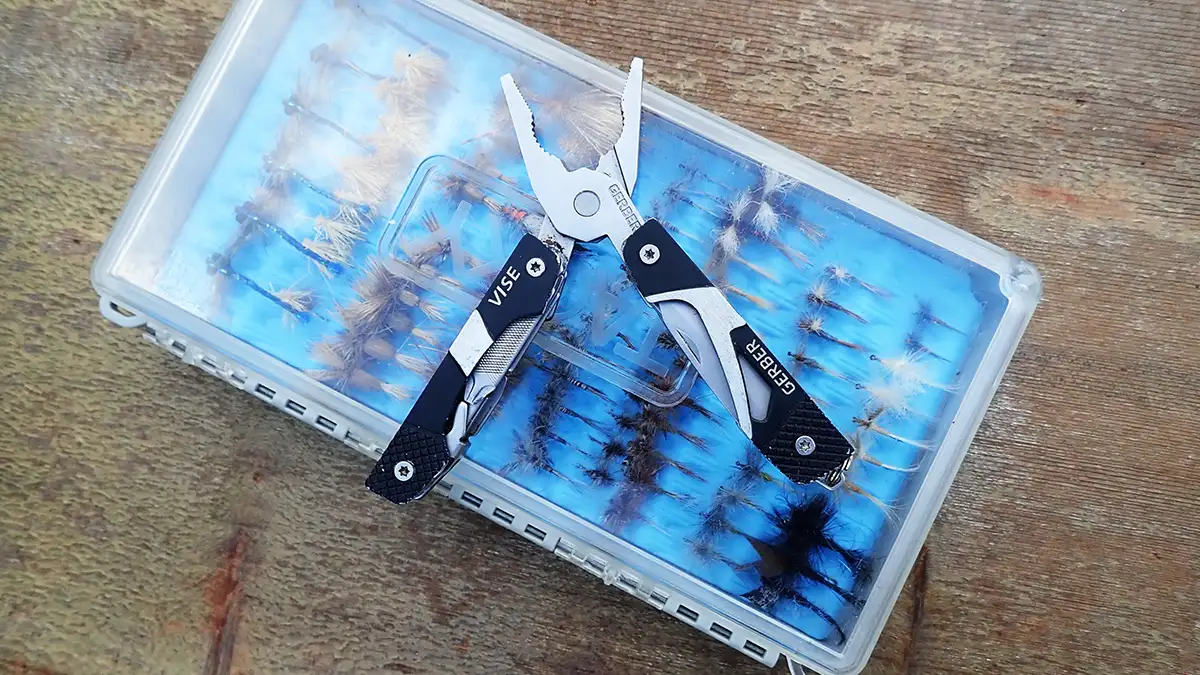 Gerber Vise on tackle box of flies