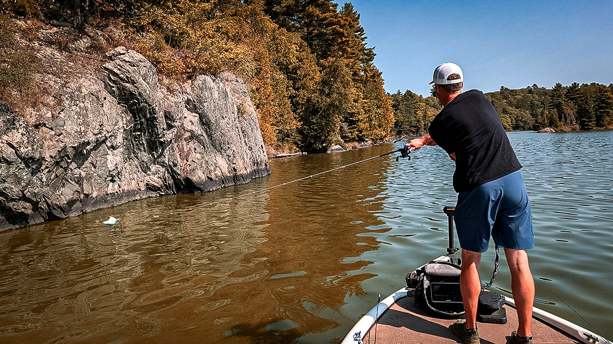 man casting from bow of boat