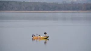 bass boat in middle of lake