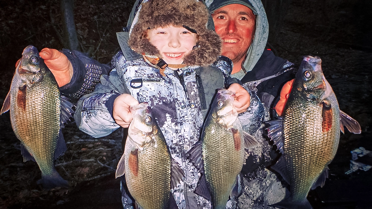 man and child holding up four fish