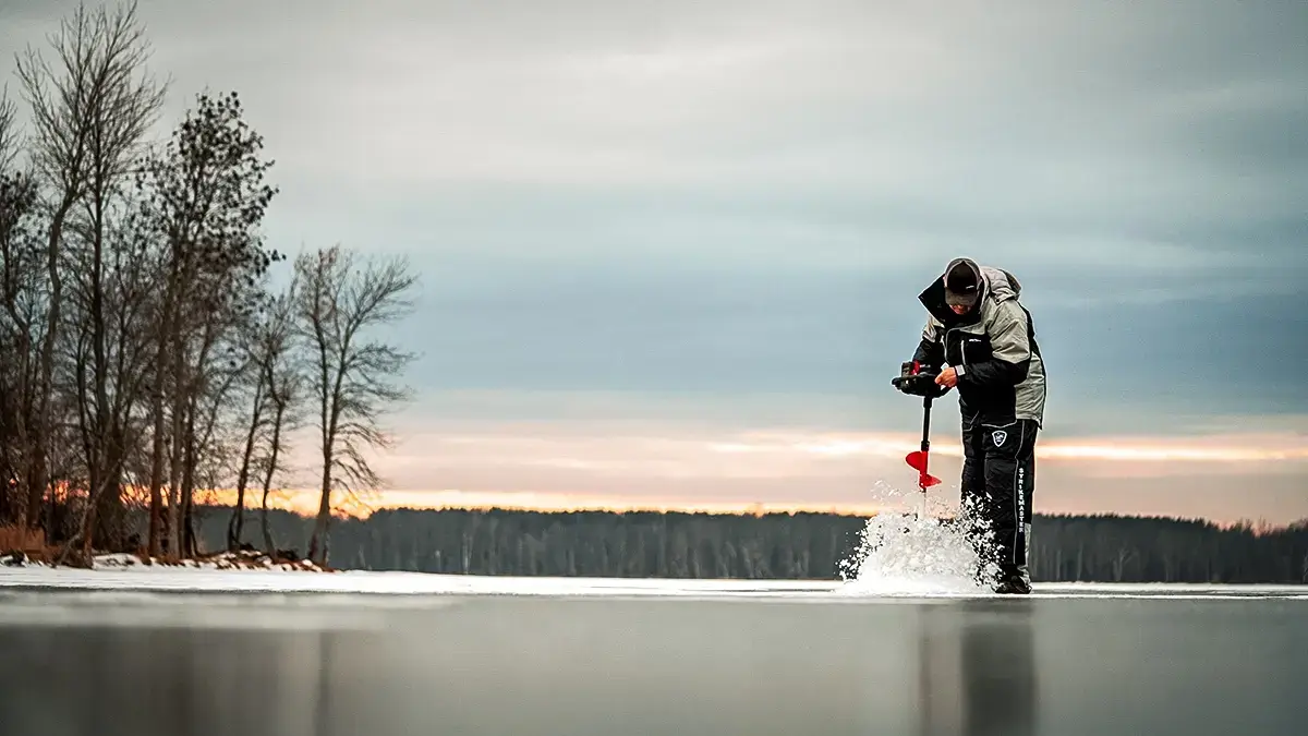 angler drilling hole with auger