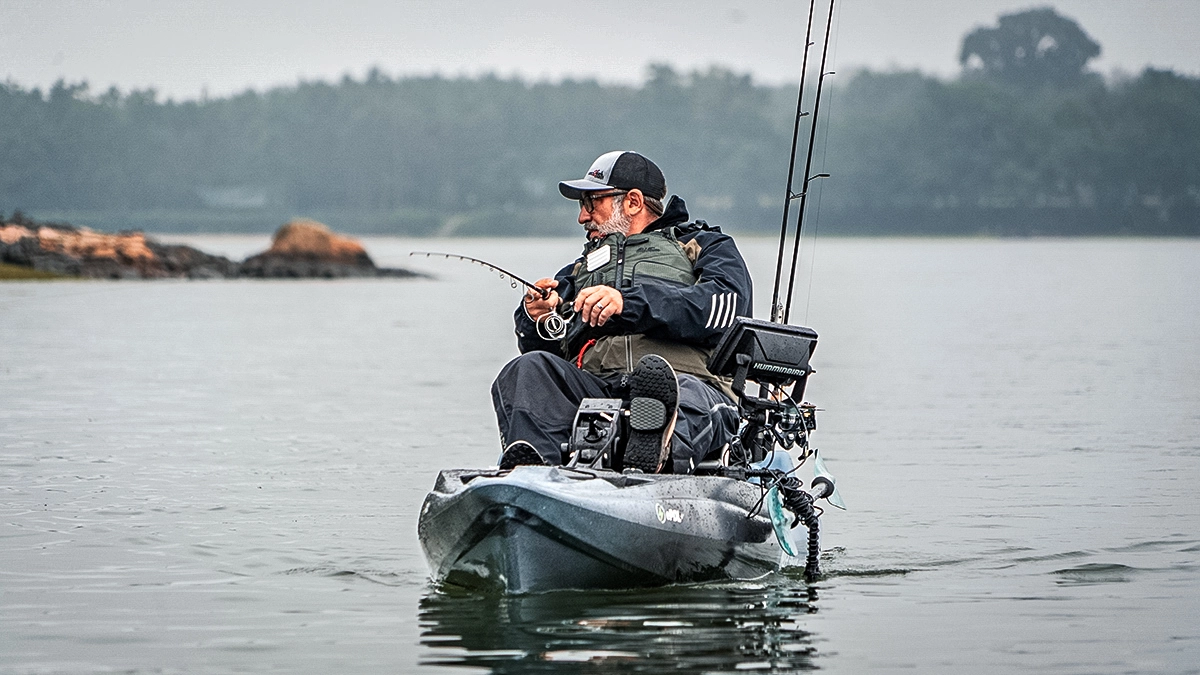 angler fishing from an old town kayak in the cold