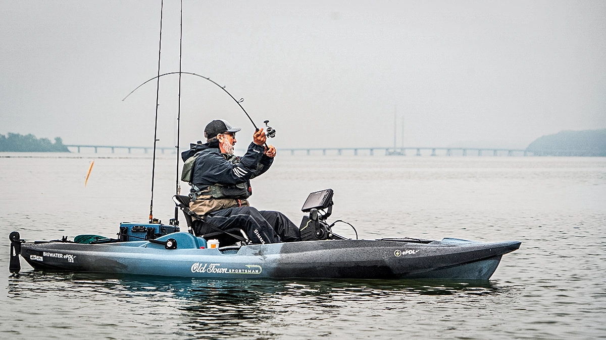 angler fishing from an old town kayak in the cold