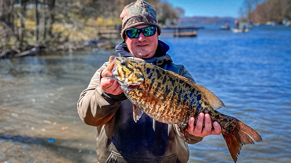 angler with a smallmouth bass