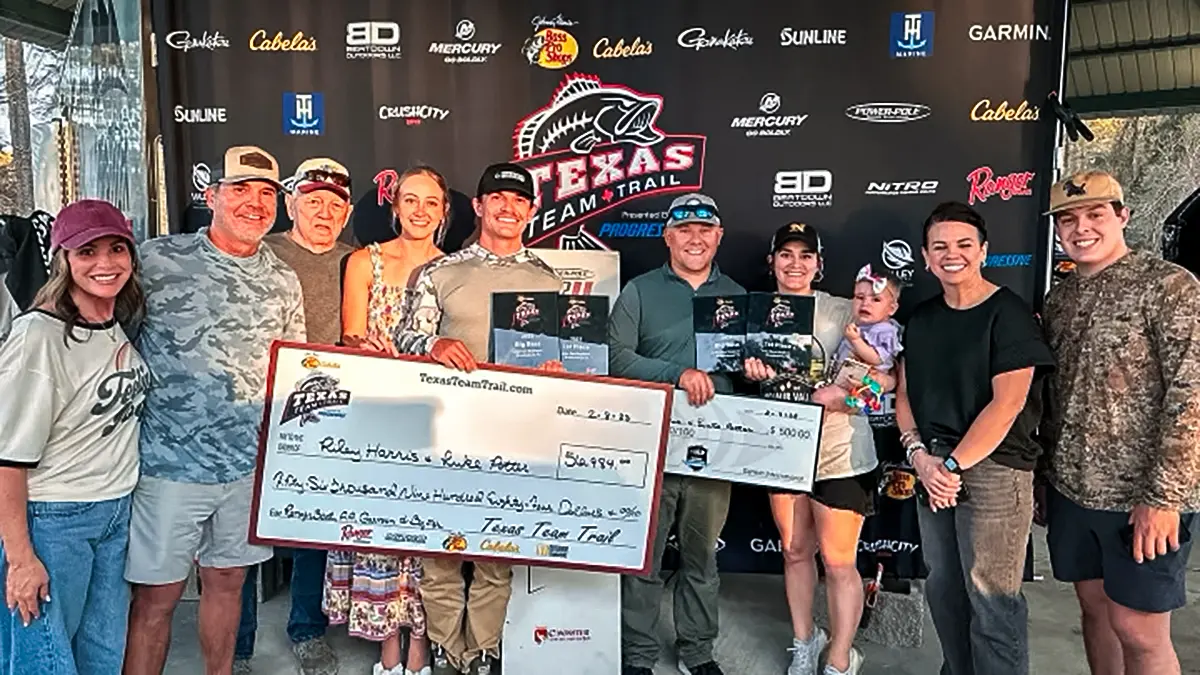 Riley Harris and Luke Potter with supporters receiving their checks for the win